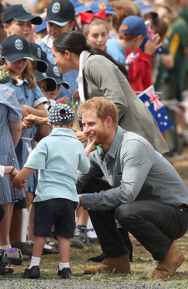 Prince Harry, Duke of Sussex and Meghan, Duchess of Sussex meet with local children as they arrive at Dubbo Airport on October 17, 2018. Picture: Cameron Spencer