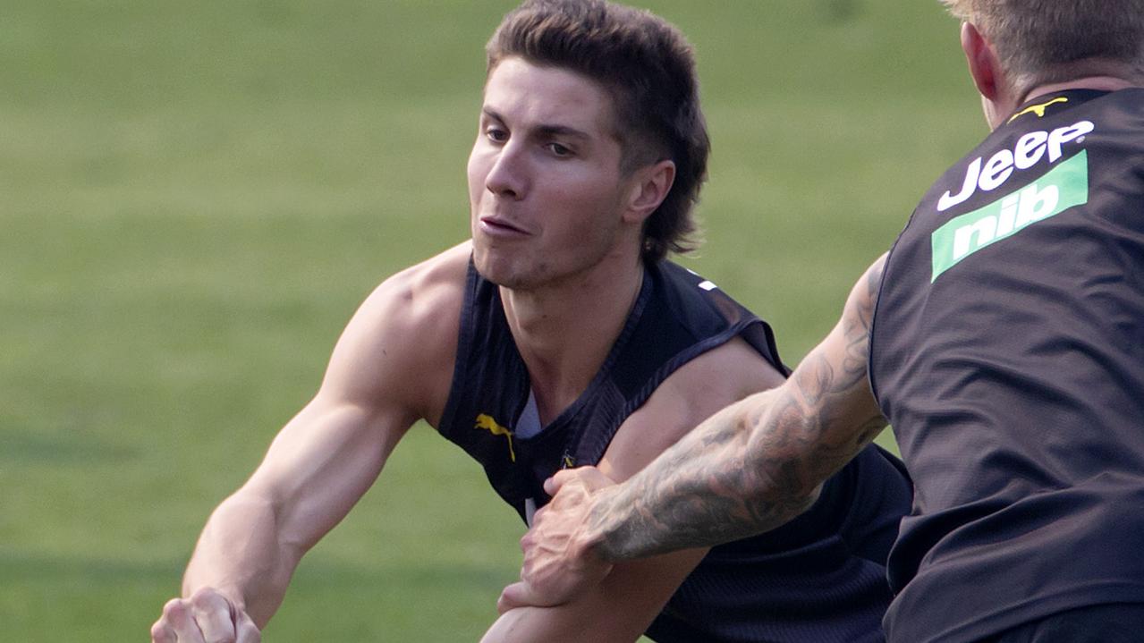 Liam Baker shoots a handball along the ground at Richmond training.