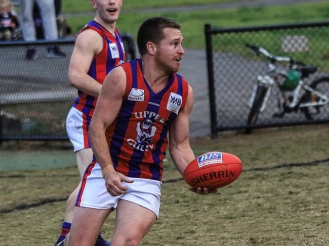 Tim Riseley dishes off a handball for Upper Ferntree Gully in the Eastern Football League (EFL). Picture Davis Harrigan