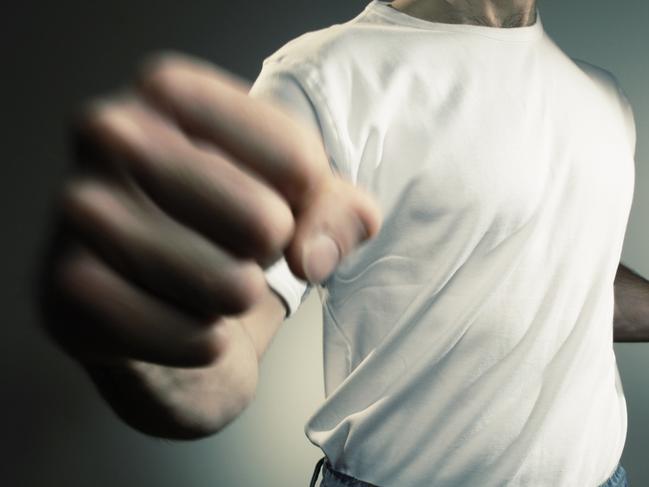 man in white t shirt and jeans throwing punch with motion blur -add text/graphics