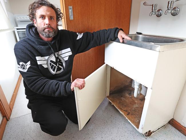 Matthew Rooke with some of the mould inside his South Hobart unit. Picture: ZAK SIMMONDS