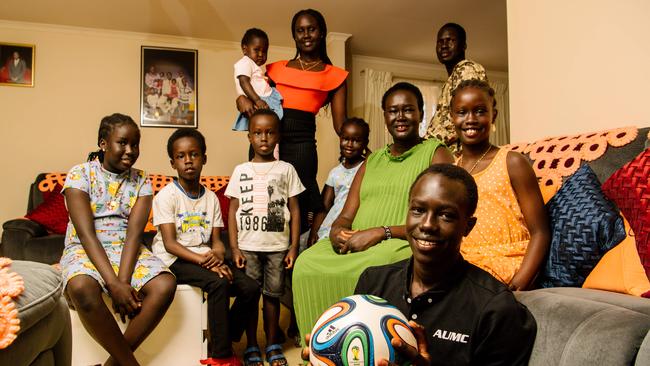 Jok Akuien, 15, holding a soccer ball, with the 10 members of his household in Adelaide. Picture: AAP Image/ Morgan Sette