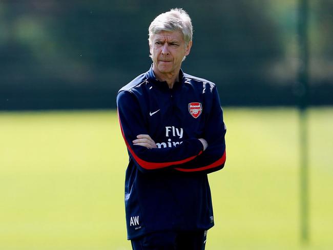 Arsenal manager Arsene Wenger, pauses, during a training session with his team, in London Colney, Hertfordshire, Wednesday May 14, 2014. Arsenal are playing Hull City in the FA Cup final on Saturday. (AP Photo/PA, David Davies) UNITED KINGDOM OUT NO SALES NO ARCHIVE