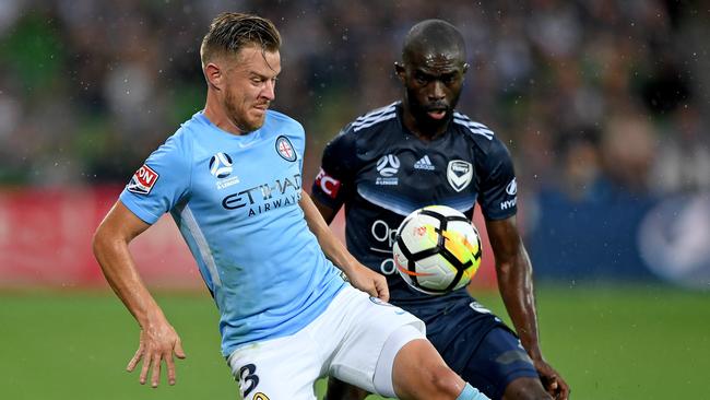 Scott Jamieson gets to the ball ahead of Victory’s Jason Geria in the December derby at AAMI Park. Picture: AAP