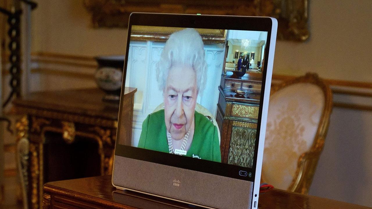 Queen Elizabeth appears on a screen via videolink from Windsor Castle today. Picture: AFP