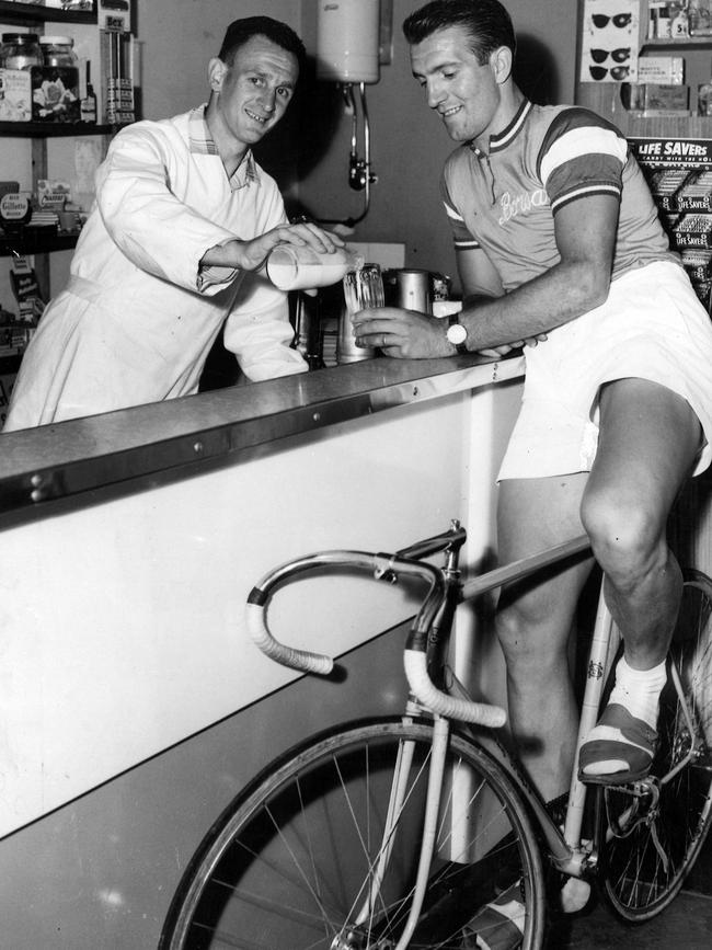 Leo Leonard pours a milkshake for his new cycling partner, Giuseppe Chiesa, at his milk bar in Bay St, Port Melbourne in 1958.