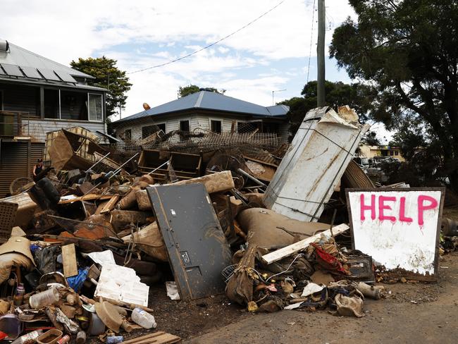 News Awards 2022 finalist pictures.   DAILY TELEGRAPH MARCH 9, 2022. PLEASE CONTACT PIC EDITOR KRISTI MILLER BEFORE PUBLISHING. Help written on a growing pill of destroyed household items by the flooding Wilsons River, outside a home on Elliott Rd in South Lismore. Picture: Jonathan Ng