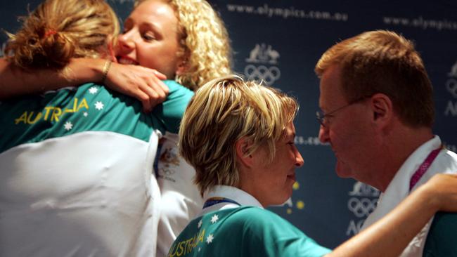 Rower Kyeema Doyle hugs Julia Wilson, and Katie Foulkes with John Coates at the 2004 Athens Olympics.