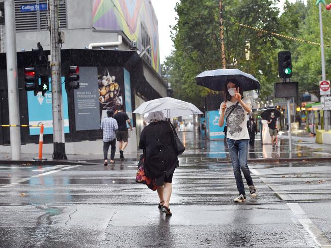 Shoppers getting caught in heavy rain in Melbourne CBD in January 2022. Picture: Nicki Connolly