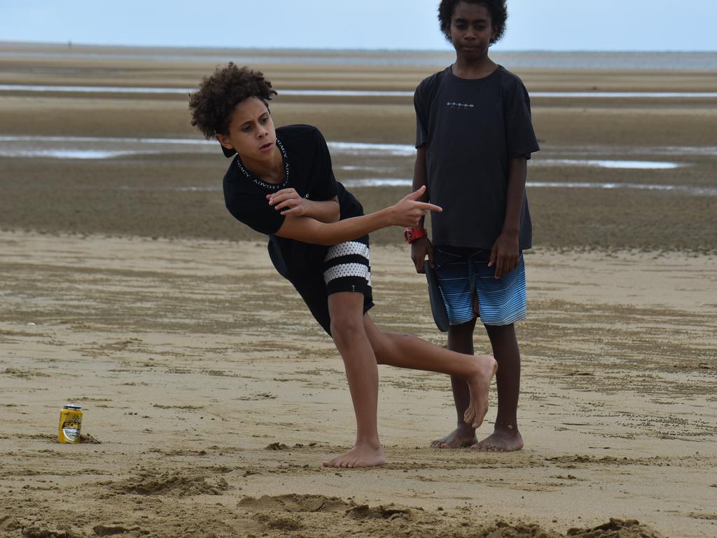 Harper Davis thong-throwing with Esaias Woyse watching at the Mackay & District South Sea islander Association's 2022 Australia Day Celebrations in Quota Park. Picture: Lillian Watkins