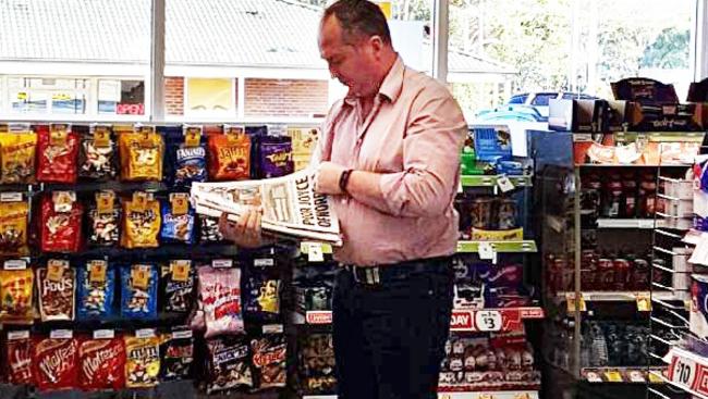 On the road again: Barnaby Joyce reads the Daily Telegraph in a service station yesterday near Goulburn.