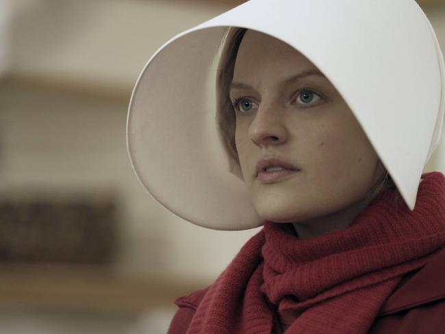 This image released by Hulu shows Elisabeth Moss as Offred in a scene from the critically acclaimed, "The Handmaid's Tale." Nominations for the 75th annual Golden Globes will be announced on Monday, Dec. 11, 2017. (George Kraychyk/Hulu via AP)