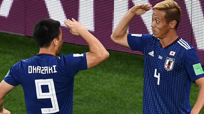 Keisuke Honda celebrates a goal with Japan's Shinji Okazaki at the Russia 2018 World Cup. Pic: AFP