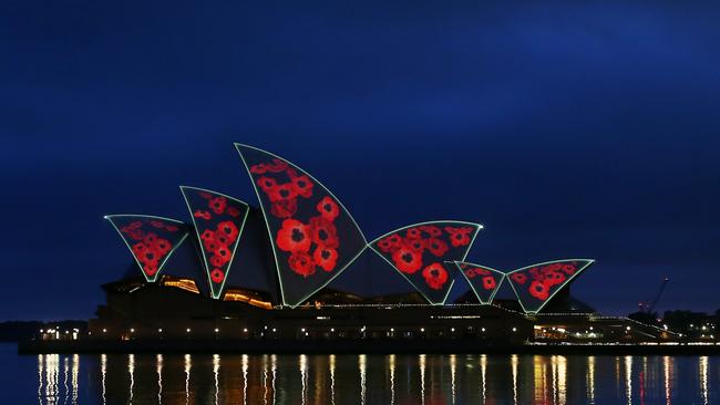 The sails of the Sydney Opera House are illuminated by a projection of poppies during a Remembrance Day Dawn Service on November 11. Picture: Getty