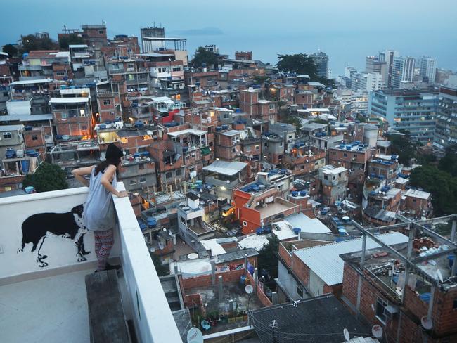 A Rio visitor takes in the view from the terrace at the Tiki Hostel in the Cantagalo "favela" community. Picture: Mario Tama/Getty Images