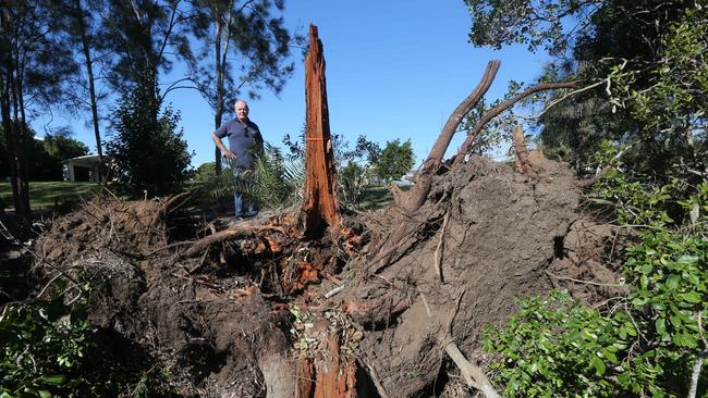 Wolfgang Schwantes pictured outside his home on the Peninsula at Helensvale showing the erosion and drop-off to Saltwater Creek. Picture Mike Batterham