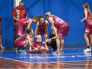 Stef Rehbein's teammates gather around after she suffers a leg injury. Picture: Brian Cassidy