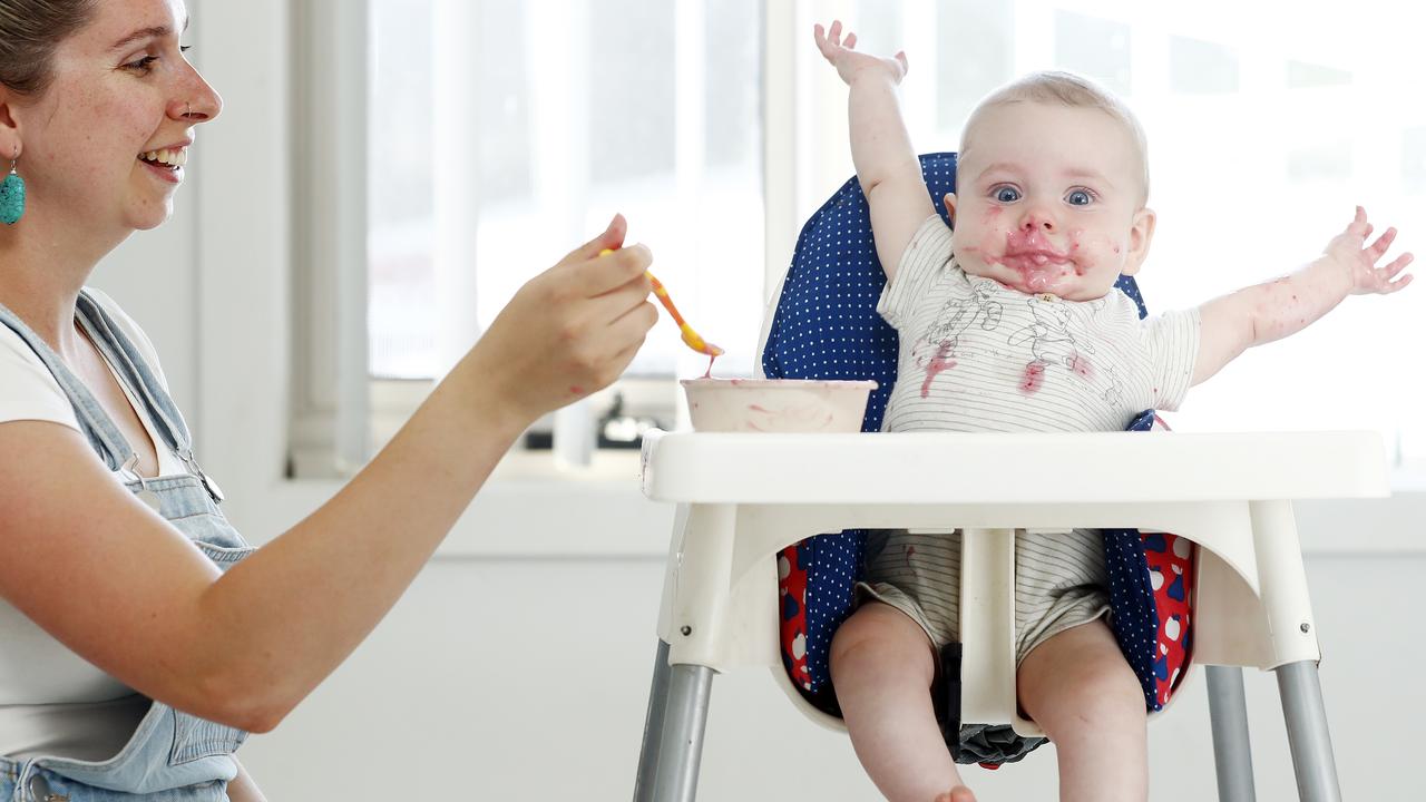 Phoebe Wise with her seven-month-old baby, Arthur Wise-Johnson, learning to eat the hard way. Picture: Sam Ruttyn