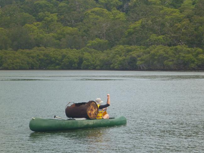 A canoeist on Georges River, south of Salt Pan Creek, collects rubbish during Clean Up Australia Day 2016.