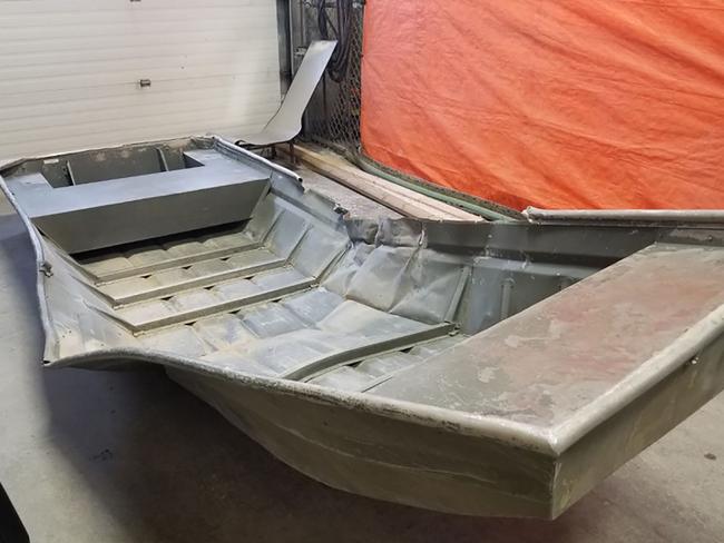 A damaged aluminium boat found on the shore of the Nelson River during the search for Kam McLeod and Bryer Schmeglsky. Picture: AFP