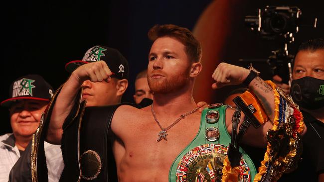 Canelo is weighed down by belts. Photo: Al Bello/Getty Images/AFP