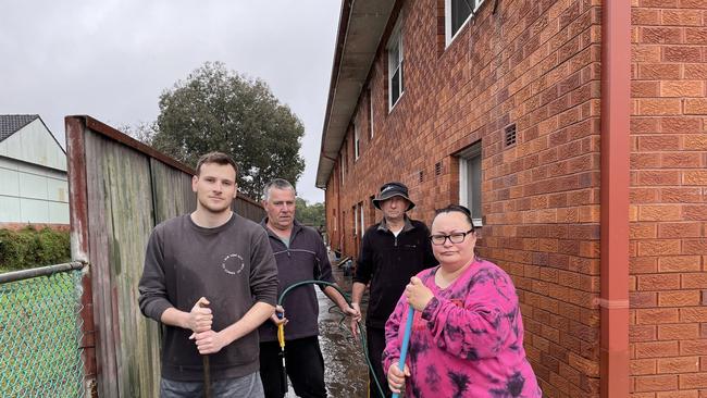 In July, Lisa Jenkin’s son Mark, her husband John, and her neighbours ﻿Syd Burton and Irena Ibrahim clean up after the latest flood event. Picture: Paul Brescia