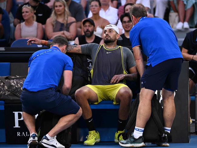 Australia's Nick Kyrgios is attended to by physios on John Cain Arena. Picture: William West.AFP.