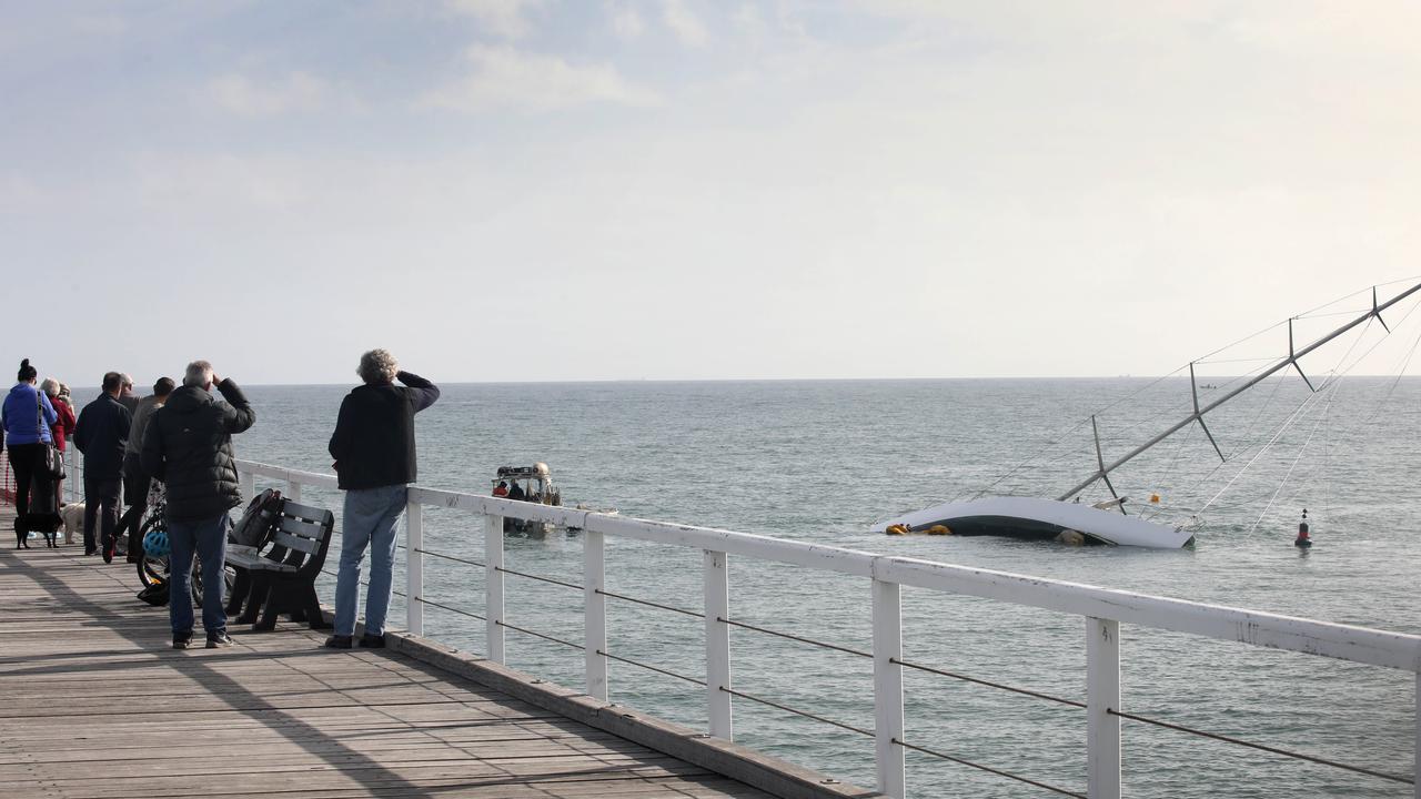 Spectators flocked to the jetty in the hopes of seeing the capsized yacht seized. Picture: NCA NewsWire/ Dean Martin