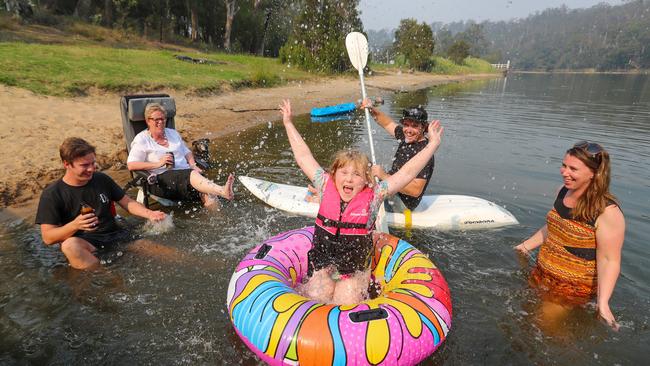 Mingling Waters Caravan Park owner Kristen Huggins and daughter Inca, 6, enjoy the local water with friends at Nowa Nowa. Picture: Alex Coppel.