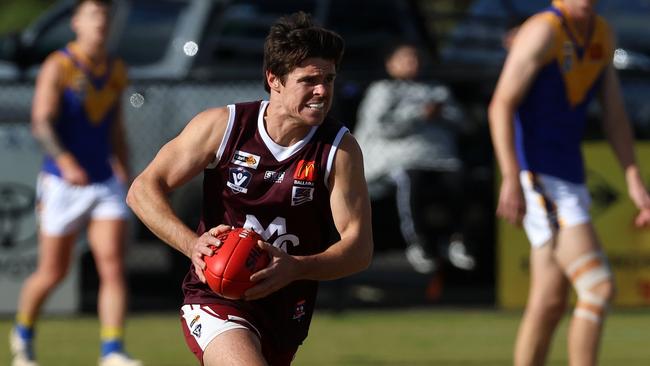 Melton’s Jack Walker charges with the ball against Sebastopol. Picture: Hamish Blair