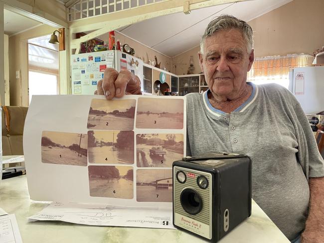 Charters Towers resident Alf Williams with some pictures he took of flooding in Aplin St and Water St with his trusty Kodak camera.