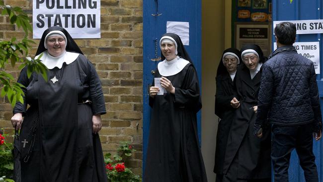 Nuns leave after casting their votes at a polling station in London, on June 23, 2016, as Britain holds a referendum on whether to stay or leave the European Union (EU). Millions of Britons began voting Thursday in a bitterly-fought, knife-edge referendum that could tear up the island nation's EU membership and spark the greatest emergency of the bloc's 60-year history. / AFP PHOTO / JUSTIN TALLIS