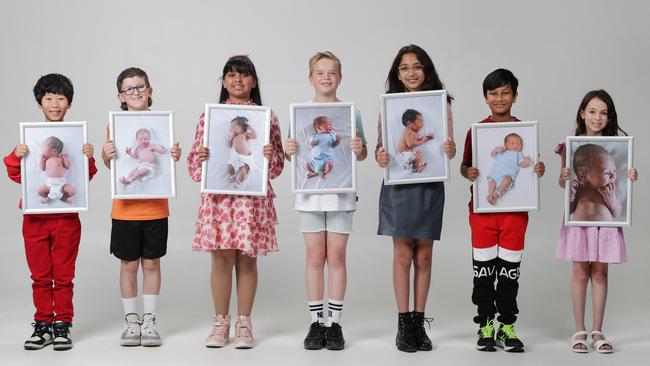 100 Babies 10 years on. 10 year olds - Andy Zhu, Koby Robertson, Emaira Tomar, Ben Steinhauser, Saira Bakshi, Ruansh Chowdhury, Bianca Sommers hold photos of them as babies. Picture: David Caird                           Picture: David Caird