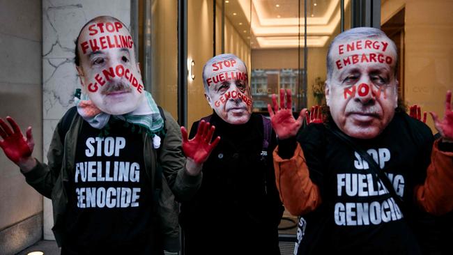 Protesters wear masks as they gather for a combined march for Global Climate Justice. Picture: AFP