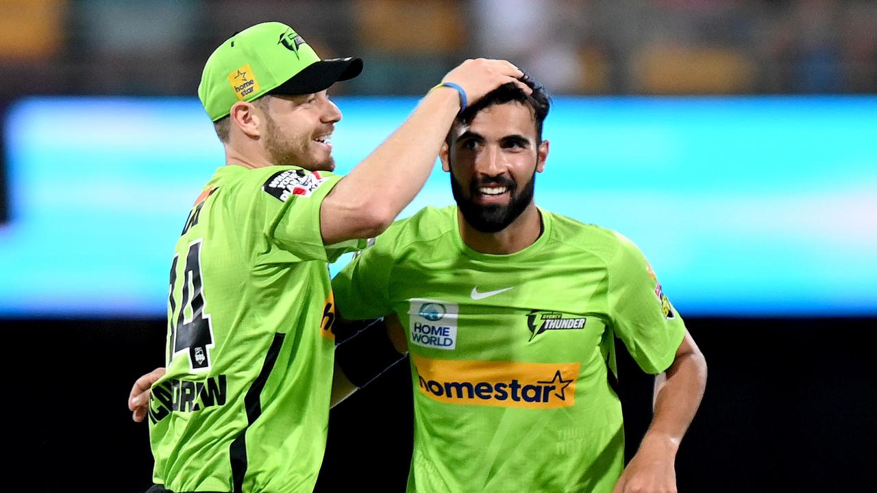 BRISBANE, AUSTRALIA - DECEMBER 19: Saqib Mahmood of the Thunder celebrates taking the wicket of Chris Lynn of the Heat during the Men's Big Bash League match between the Brisbane Heat and the Sydney Thunder at The Gabba, on December 19, 2021, in Brisbane, Australia. (Photo by Bradley Kanaris/Getty Images)
