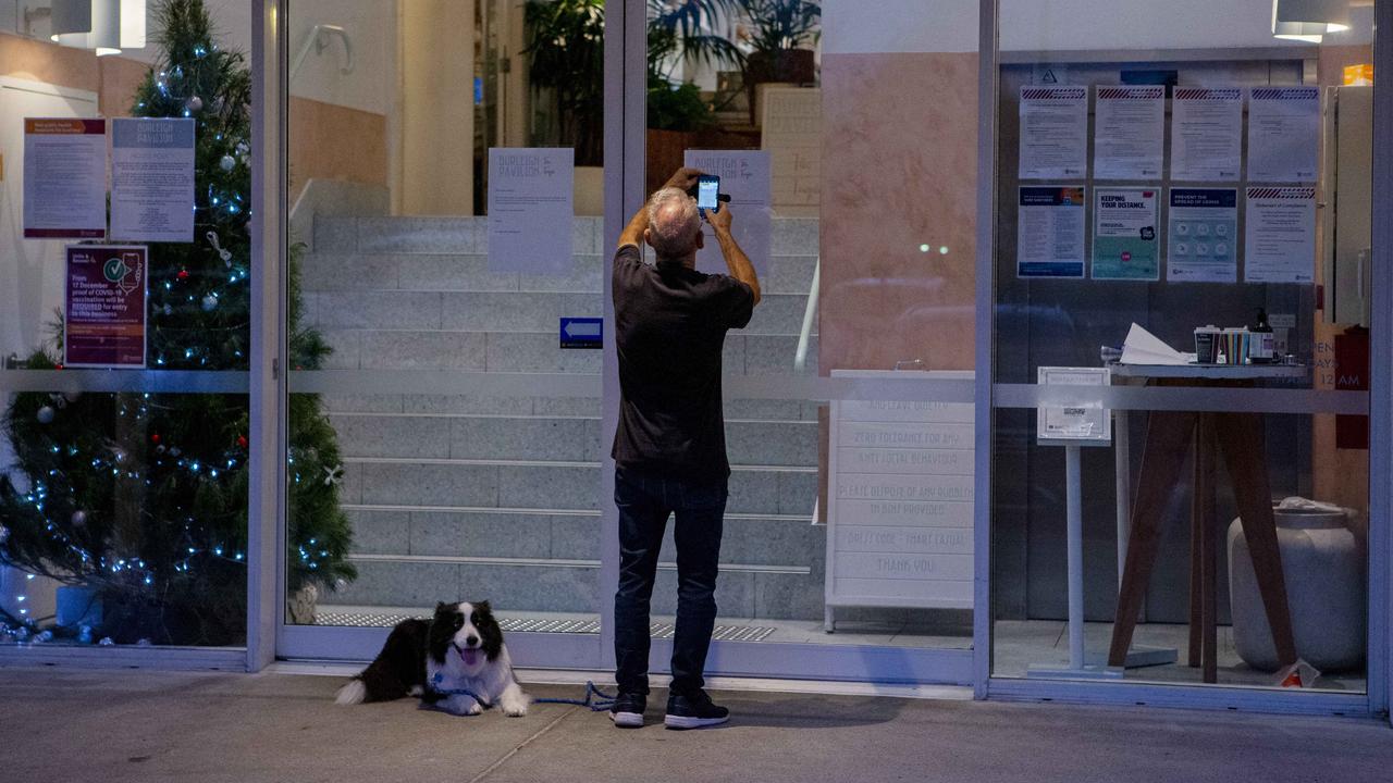 A passer-by at the front doors to the Burleigh Pavilion on Friday night. Picture: Jerad Williams