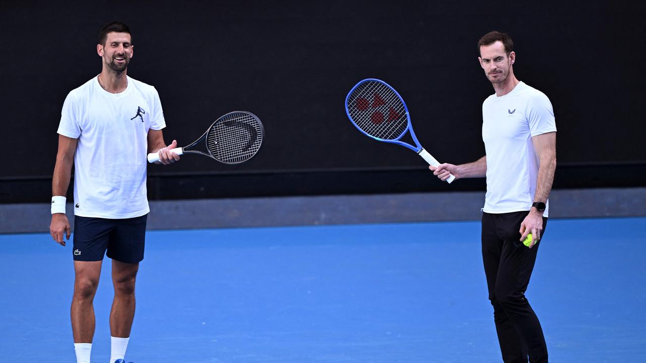 Novak Djokovic of Serbia (L) and coach Andy Murray look on during a training session ahead of the Australian Open tennis tournament in Melbourne on January 7, 2025. (Photo by William WEST / AFP)