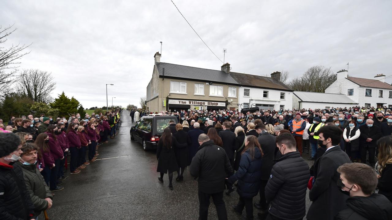 Family members and mourners follow the hearse as it leaves St Brigid’s after the funeral service. Picture: Charles McQuillan/Getty Images