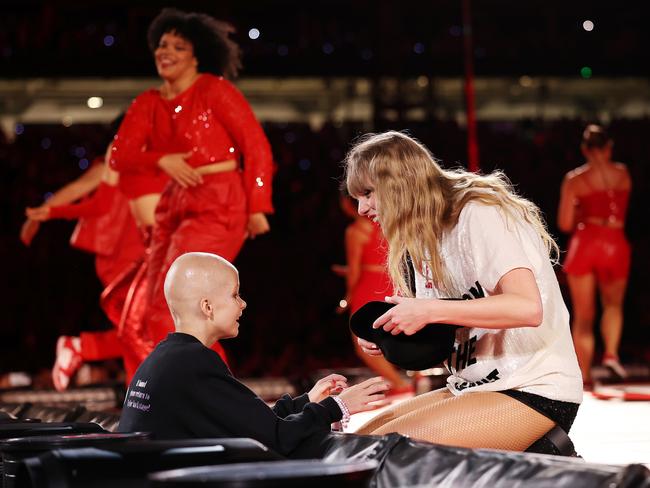 SYDNEY, AUSTRALIA - FEBRUARY 23: EDITORIAL USE ONLY. NO BOOK COVERS A young fan receives a hat from Taylor Swift during her performance at Accor Stadium on February 23, 2024 in Sydney, Australia. (Photo by Don Arnold/TAS24/Getty Images for TAS Rights Management)