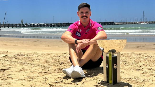 Sydney Sixers star Ben Dwarshuis with the Big Bash League trophy during a visit to Coffs Harbour on Tuesday.