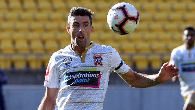 Joss Hoffman of the Newcastle Jets controls the ball.