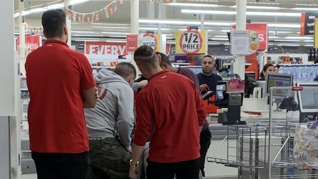 A man who allegedly struck a Coles employee was detained by staff and shoppers.