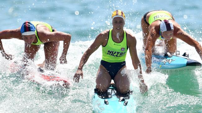 Electra Outram, right, competing in the surf.