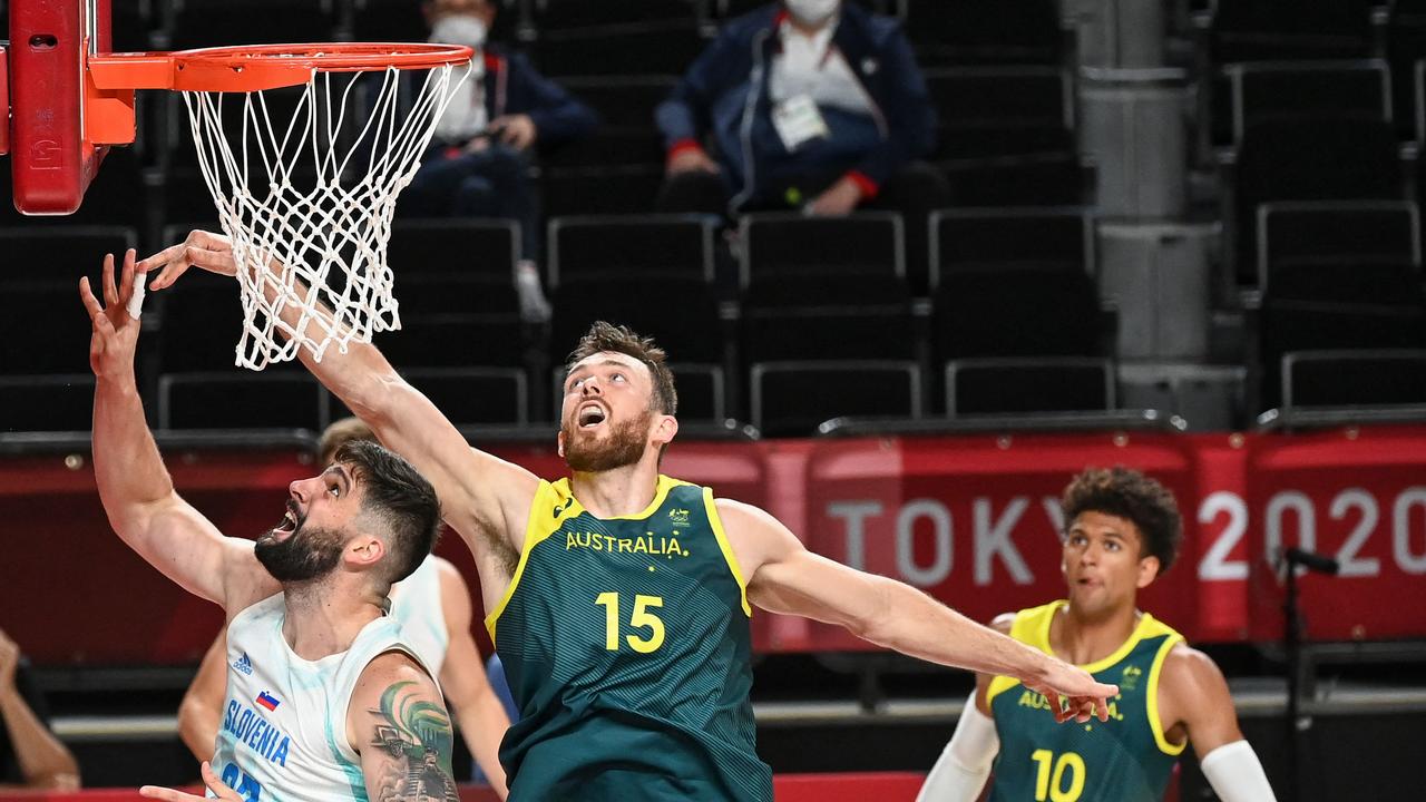 Australia's Nic Kay (2R) jumps for the rebound with Slovenia's Ziga Dimec. Picture Mohd Rasfan/ AFP