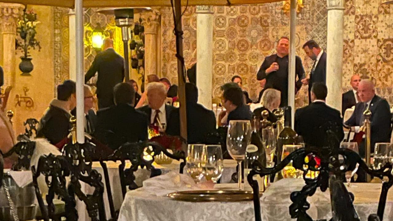 Donald Trump, his adviser Taylor Budowich, Tim Cook and Elon Musk at Mar-a-Lago on December 13. Picture: Supplied