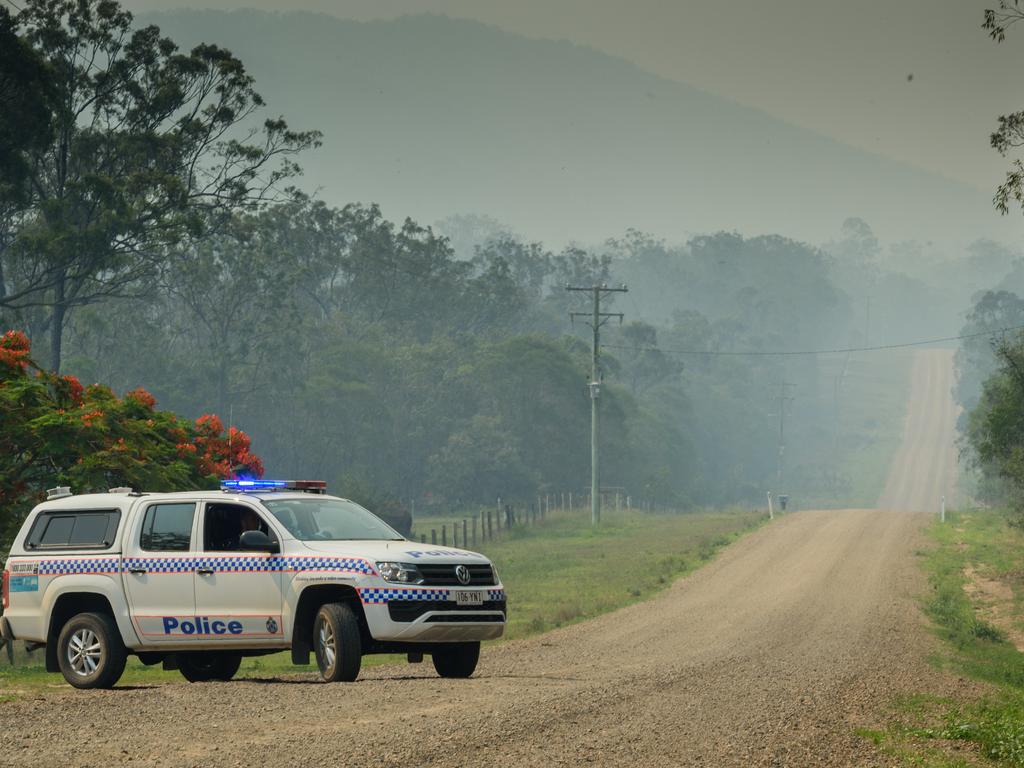 Police are seen checking houses on Muller Road at Deepwater. Picture: AAP Image/Paul Beutel