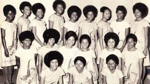 Cairns Air Niugini employees Hagen Korinihona (sixth from left back row) and Annemarie Rhodes (middle front row) in a 1977 cabin crew graduation photo. The pair remain as the only two staff at the Cairns Air Niugini office as the airline celebrates a 45-year relationship with the Far North.