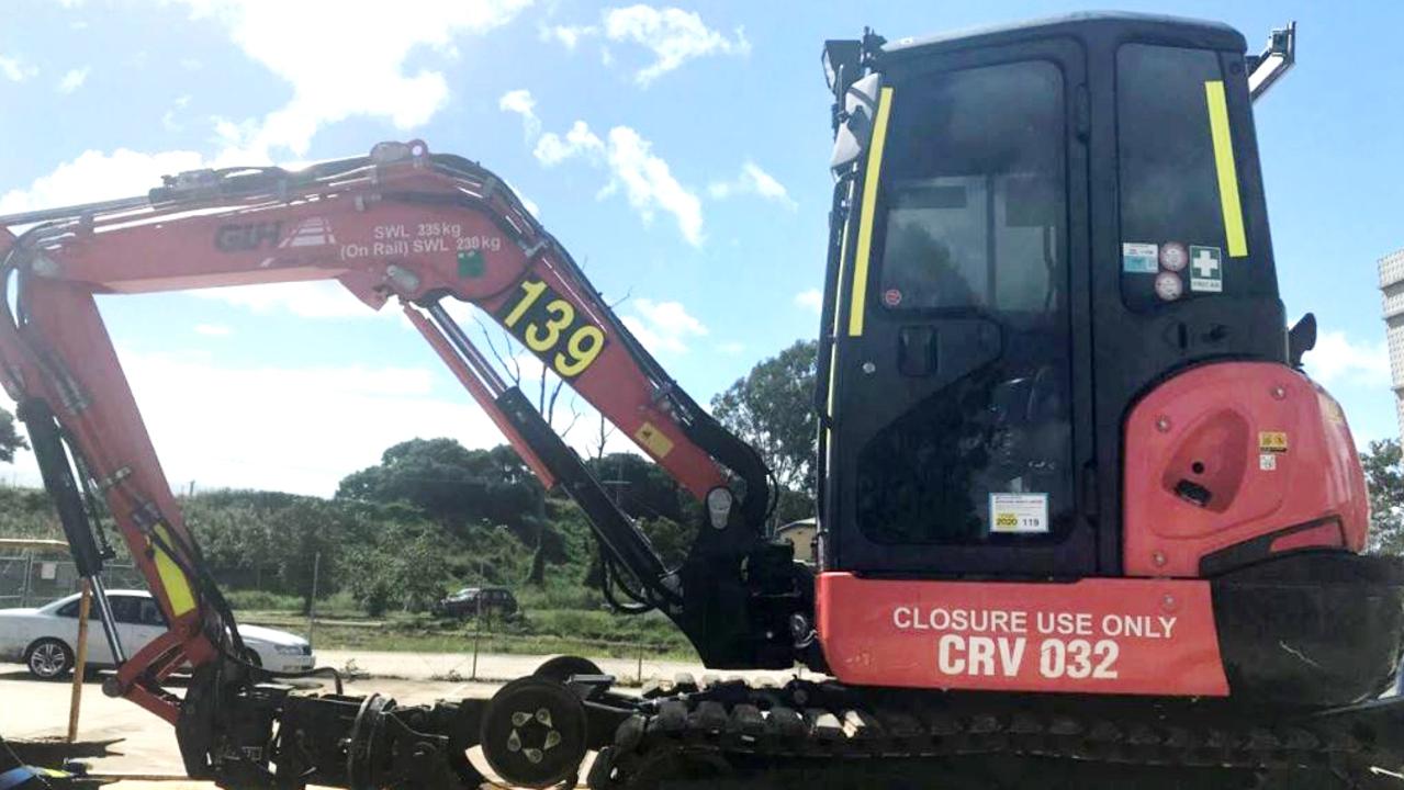 An excavator involved in a near miss with a Queensland Rail train.