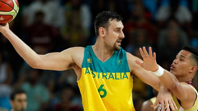 Andrew Bogut of Australia controls the ball as Windi Graterol of Venezuela defends during the preliminary round game at the Rio 2016 Olympic Games.