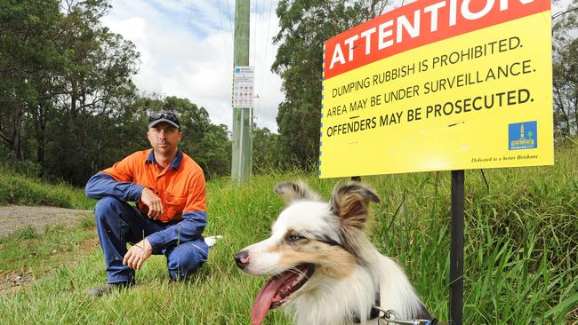 Troy Bredhauer and dog, Jess, at the site where he received the Brisbane City Council fine. Picture: JOHN GASS